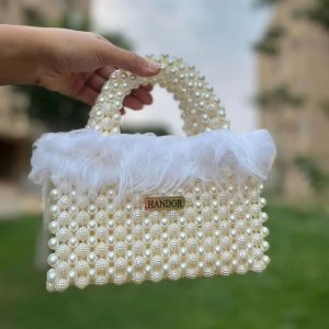 Loly handbag decorated with off white feathers