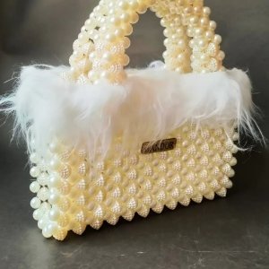 Loly handbag decorated with off white feathers