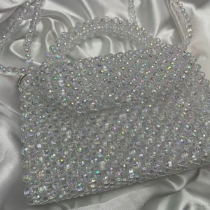 A cross reflected bead bag and a medium-sized handbag